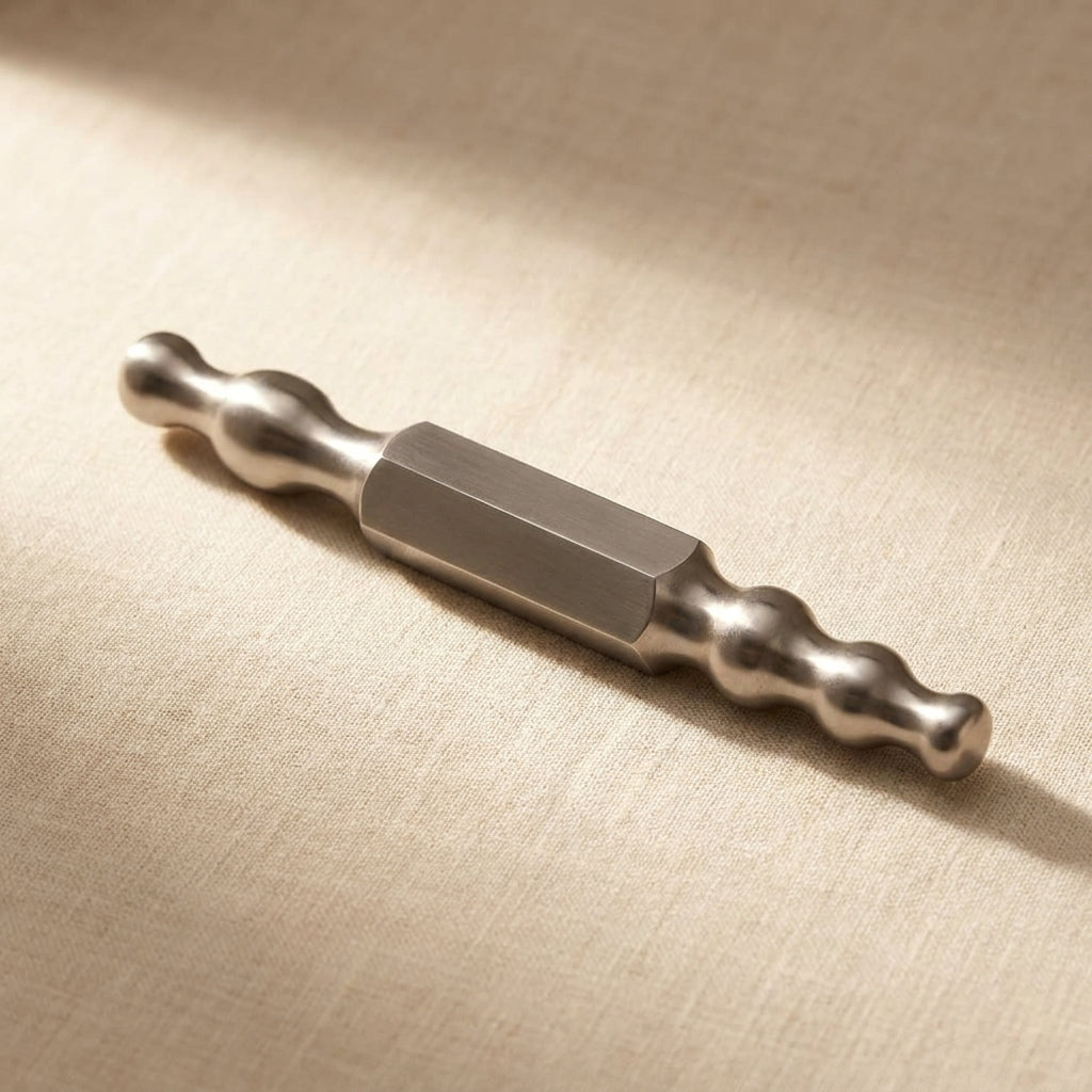 Close-up of the polished hardened steel forming stake showing its synclastic and anticlastic curves