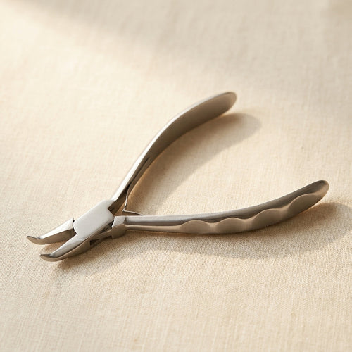 Close-up of polished stainless steel bent chain nose plier jaws for precise wire bending