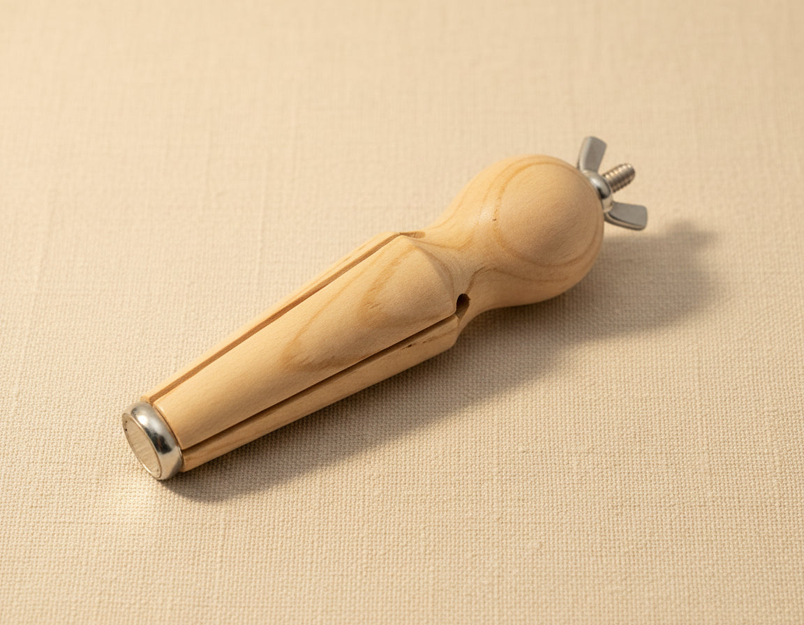 Close-up of the wooden ring holder's jaws and wing nut for tightening jewellery pieces.