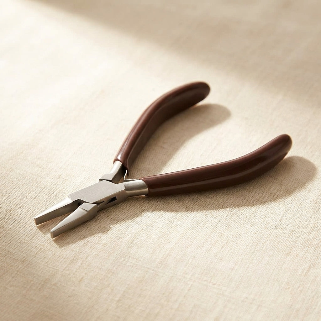 Close-up of the ergonomic PVC grip and stainless steel jaw on the flat nose jewellery pliers