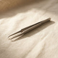 Stainless steel prong tweezers for holding small components during jewellery and watch repair.