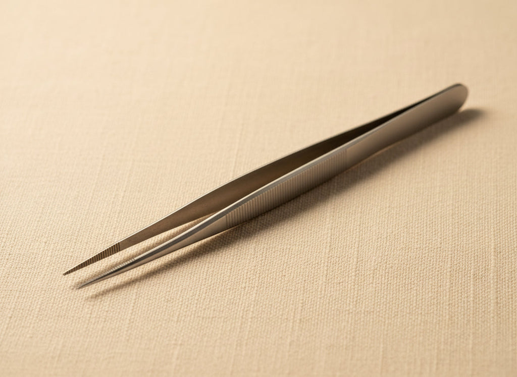 Close-up of serrated jaws of stainless steel precision tweezers for gemstone handling