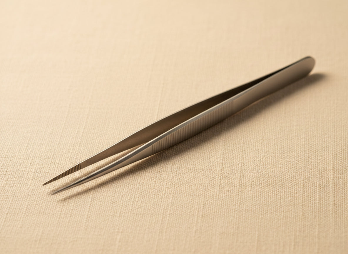 Close-up of serrated jaws of stainless steel precision tweezers for gemstone handling