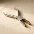 Flat nose pliers with soft brass-lined jaws for forming metalwork.