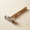 German style 28mm ball peen chasing hammer with bow face and wooden handle for silversmithing.