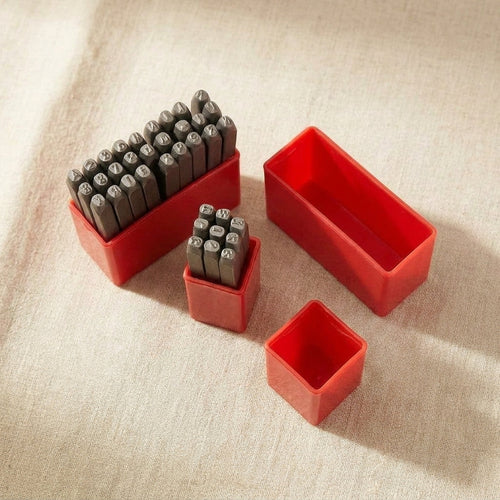 37-piece metal stamp set for jewellery makers, 4mm A-Z, 0-9, and symbols, with storage.