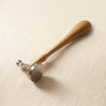 Bow and flat faced silversmith hammer with wooden handle for jewellery forming