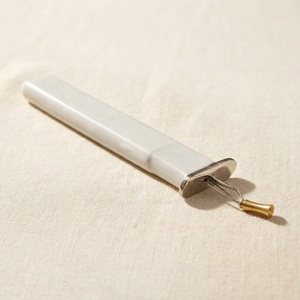 Light grey professional jewellery knotting tool for consistent bead knots, with a comfortable grip