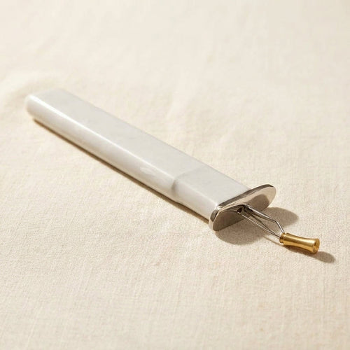 Light grey professional jewellery knotting tool for consistent bead knots, with a comfortable grip
