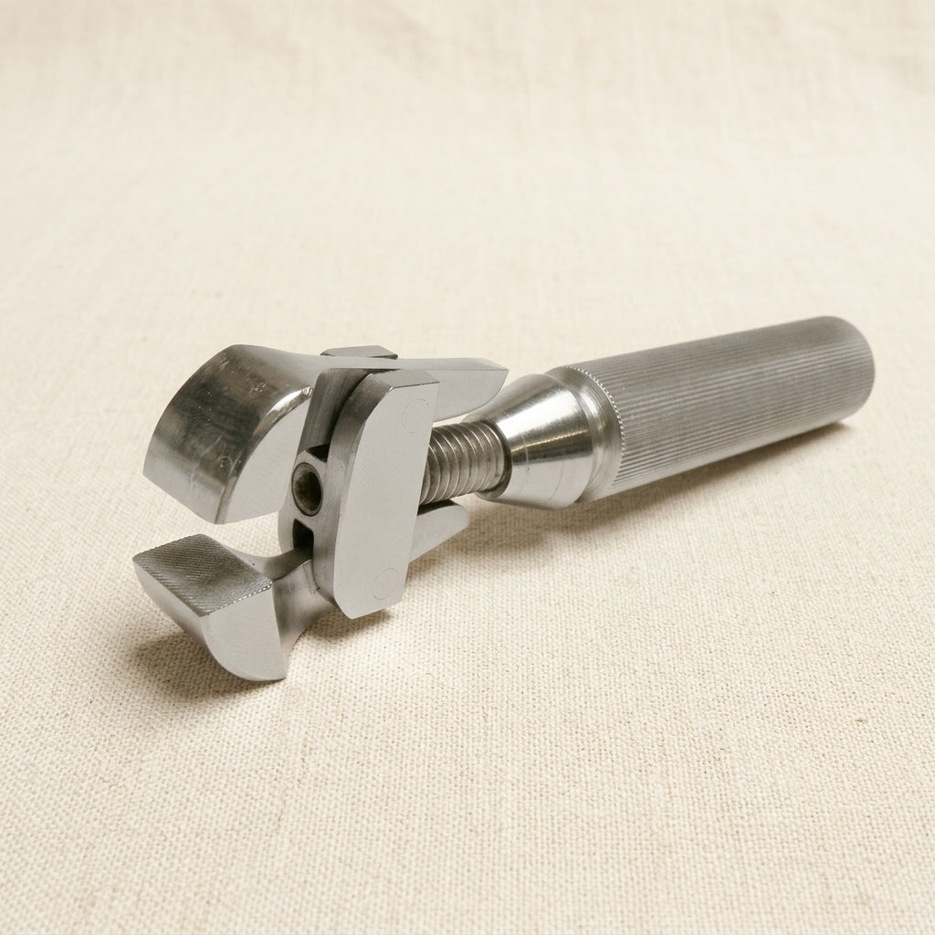 Lowell pattern hand vise for wire work, hollow handle drawtong with parallel-action jaws.