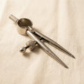 Mini spring divider caliper for jewellery layout and precise marking, with round legs and a professional finish.