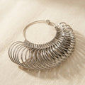 Chrome-plated metal bracelet and bangle size gauge set, 27 pieces, with US and international measurements.
