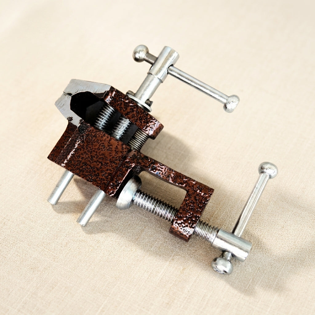 Mini cast iron bench clamp with 1-inch jaws for jewellery making and silversmithing.