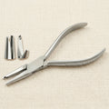 Professional optical pliers for adjusting nose pad arms on silver metal spectacle frames.