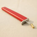 Red professional jewellery knotting tool for creating neat, consistent knots with beads.