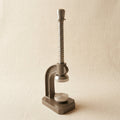 Spring-loaded metal flattening press for jewellery making, steel bench tool with parallel action mechanism