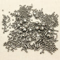 Mixed shape stainless steel jewellery polishing media, 1kg bag, containing spheres, cones, and pins.