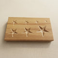 Wooden dapping block for shaping jewellery metal with seven star-shaped cavities