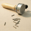 Hand-held jewellers vise with 8 pins for secure workholding during engraving and silversmithing