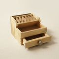 Natural wood jewellery tool organiser with seven compartments and storage drawers, 16.5cm wide.