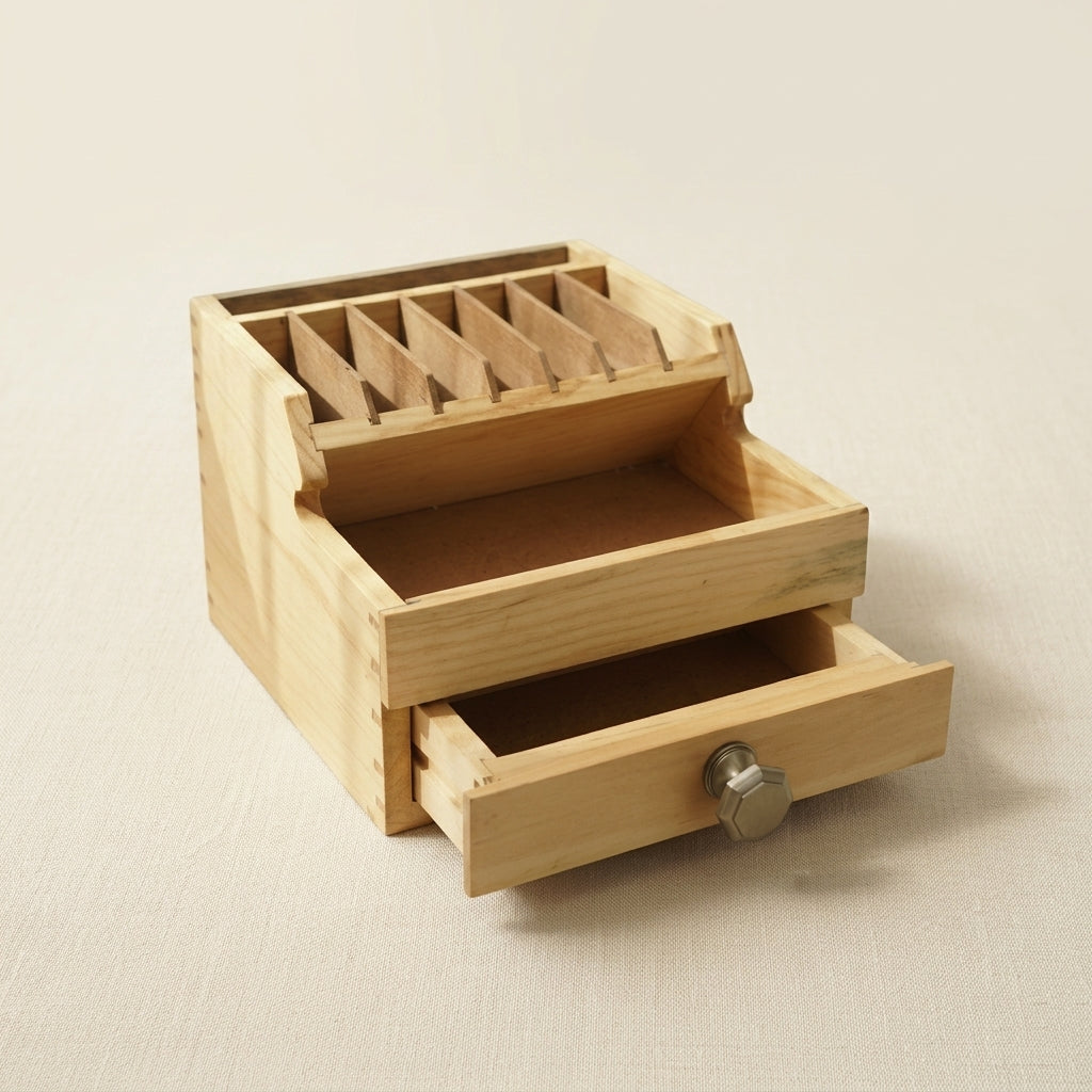 Natural wood jewellery tool organiser with seven compartments and storage drawers, 16.5cm wide.