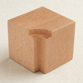 Wooden block for holding jewellery stamps securely during metal marking.