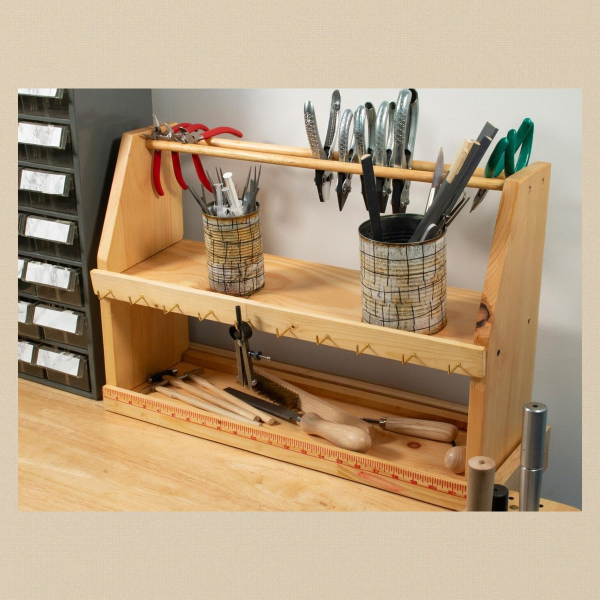 The organiser in use on a jewellers bench with pliers, files and tool pots